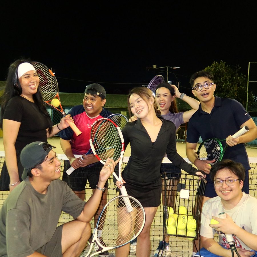 Barkada Night 01: friends laughing at the net on a lit court at night