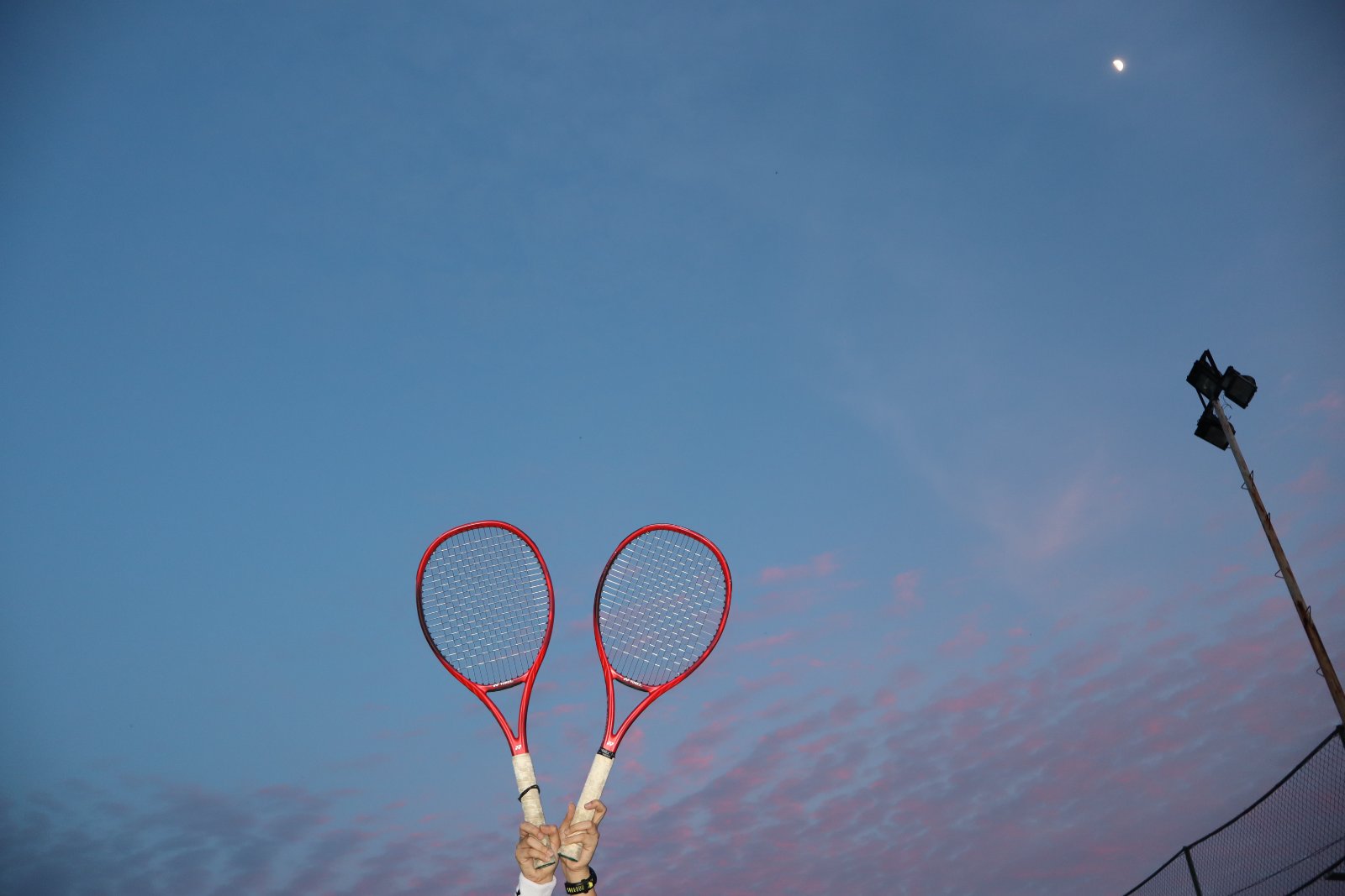 Rackets raised at dusk