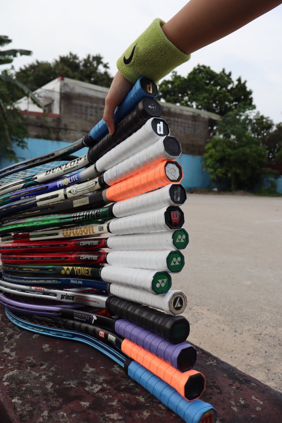 Stack of rental rackets held by hand