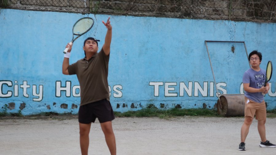 Player serving at South City Homes Tennis Club